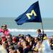 A young Michigan fan gets a better view as he sits near a block M flag while the marching band performs for fans during beach day in Clearwater, Fla. on Sunday, Dec. 30. Melanie Maxwell I AnnArbor.com